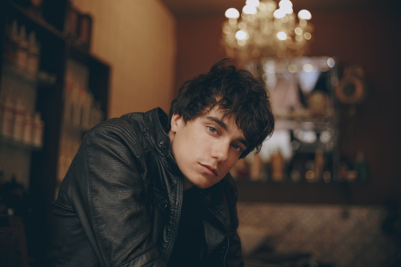 lifestyles, looking at camera, black leather jacket, model, male, contemplation, lights, depth of field, young men, wear, leisure activity, photoshoot