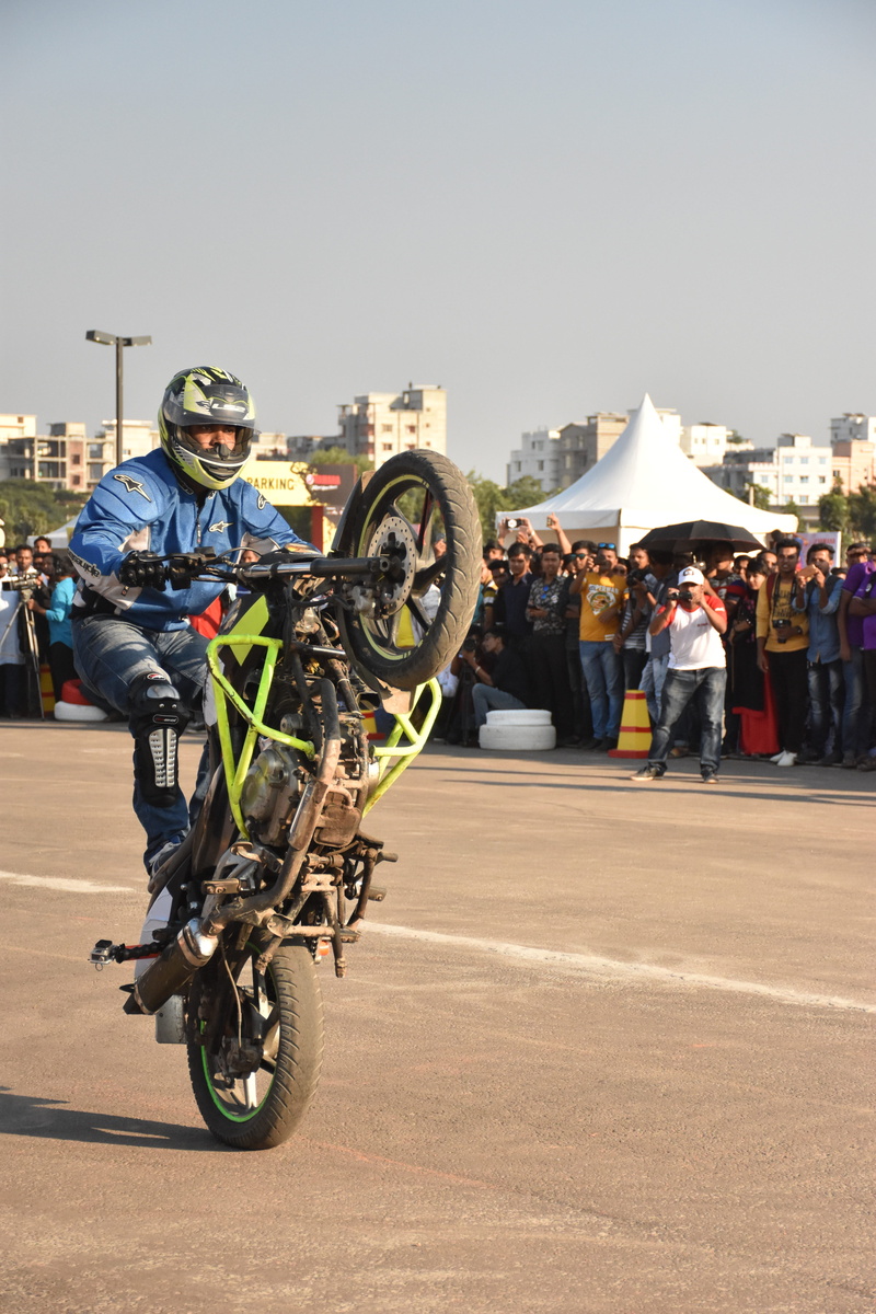 full length, ride, headwear, sunlight, city, people, sky, mode of transportation, motocross, man, outdoors, athlete, sport, group of people, real people