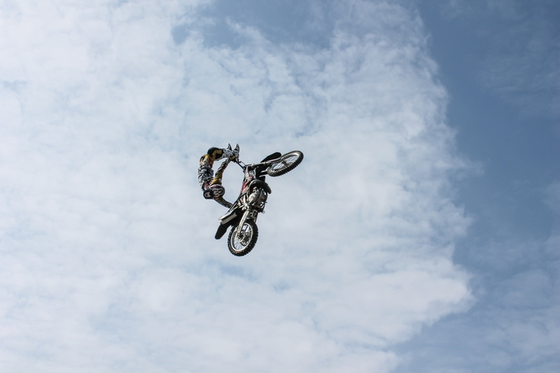 ride, real people, stunt, speed, riding, outdoors, mid-air, cloud - sky, sport, sky, skill, one person, mode of transportation, crash helmet, person, low angle view