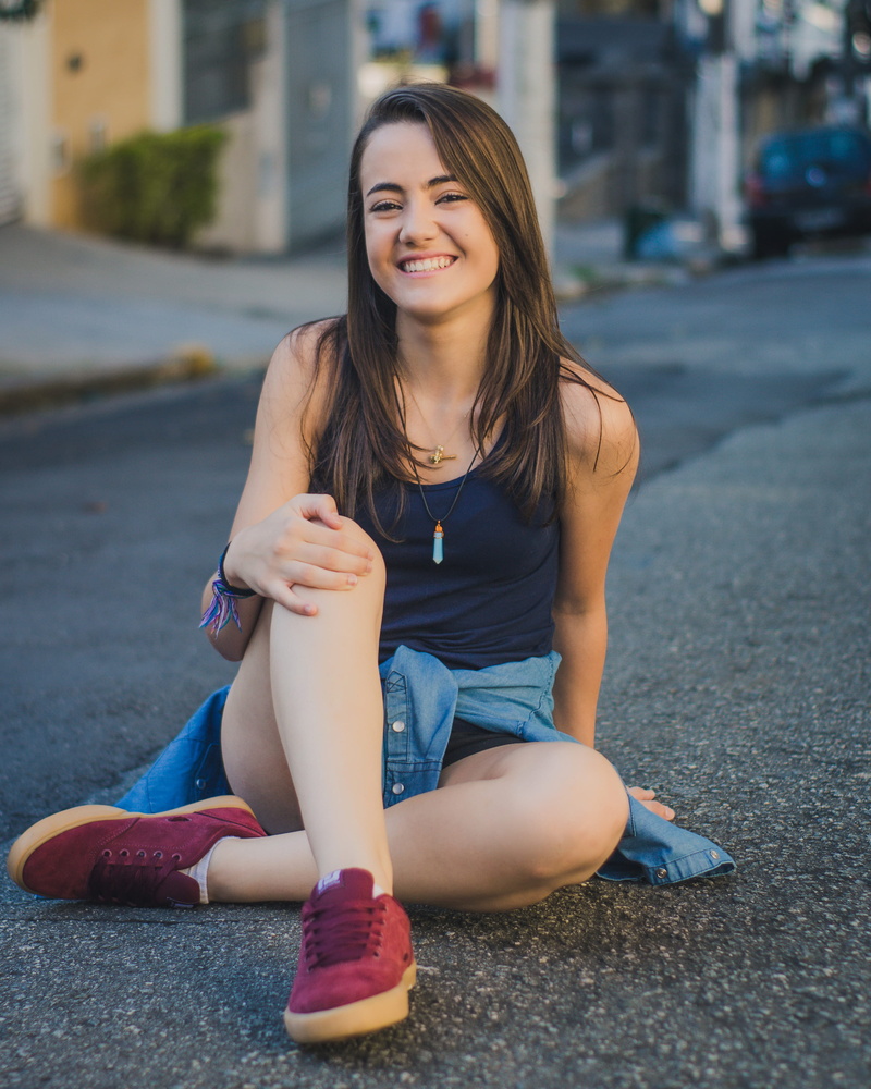 person, smiling, real people, focus on foreground, pendant, looking, shorts, focus, women, beautiful, depth of field, road, architecture, leisure, female