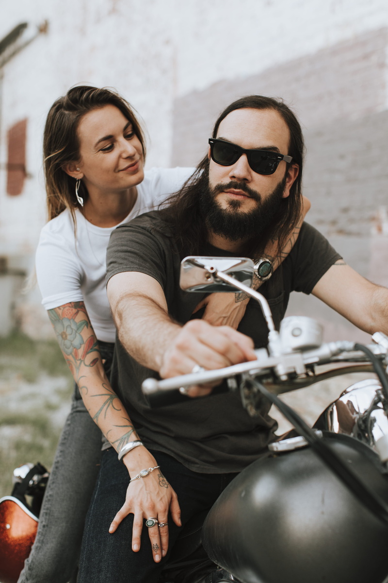 eyewear, boyfriend, people, bonding, men, males, blur, hug, lifestyles, smiling, motorcycle, facial expression, glasses, bikers, long hair, happiness, fashion