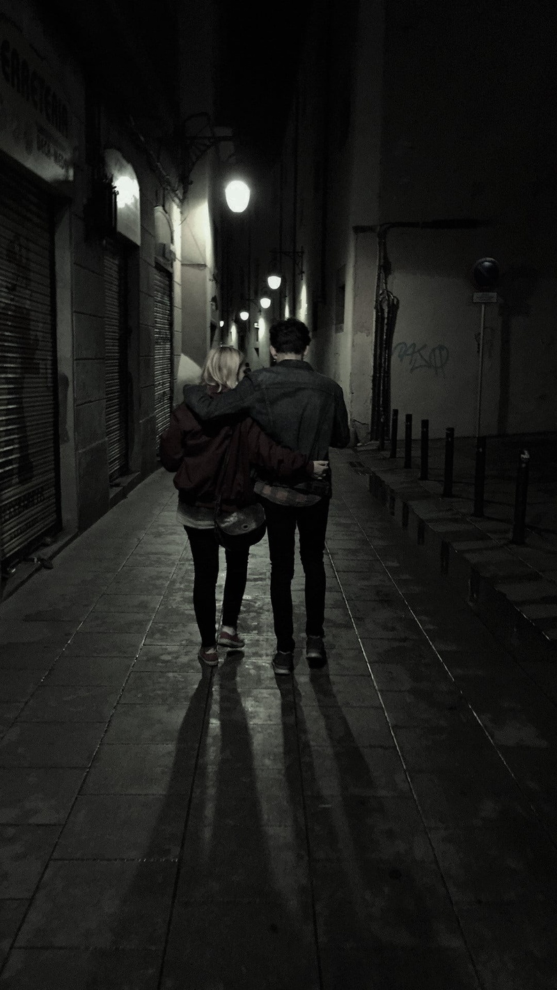 night, real people, illuminated, city, lifestyles, barcelona, electric lamp, lighting equipment, direction, adult, people, togetherness, rear view, full length