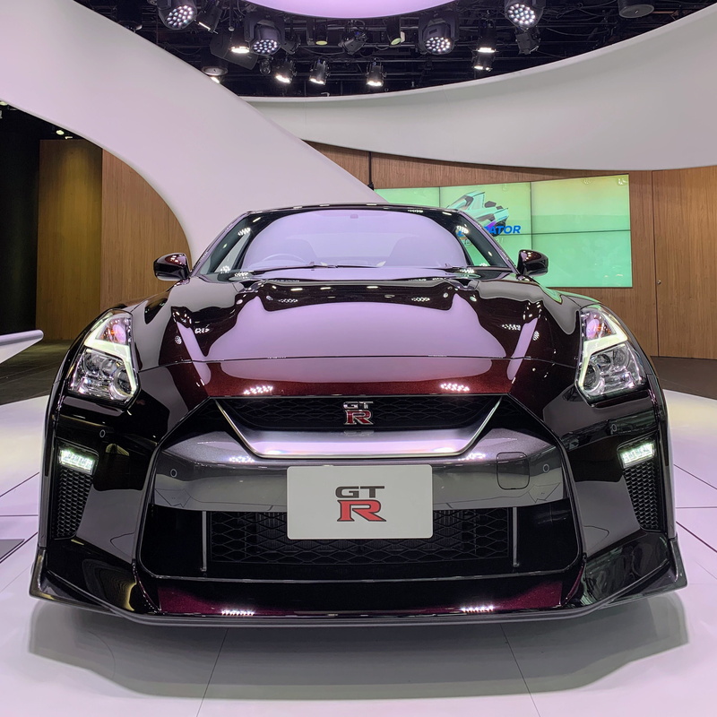 shiny, indoors, tire, wheel, car show, 5 chome-7-2 ginza, chūō-ku, showroom, machine, helmet, built structure, car, nissan, auto racing, architecture, mode of transportation