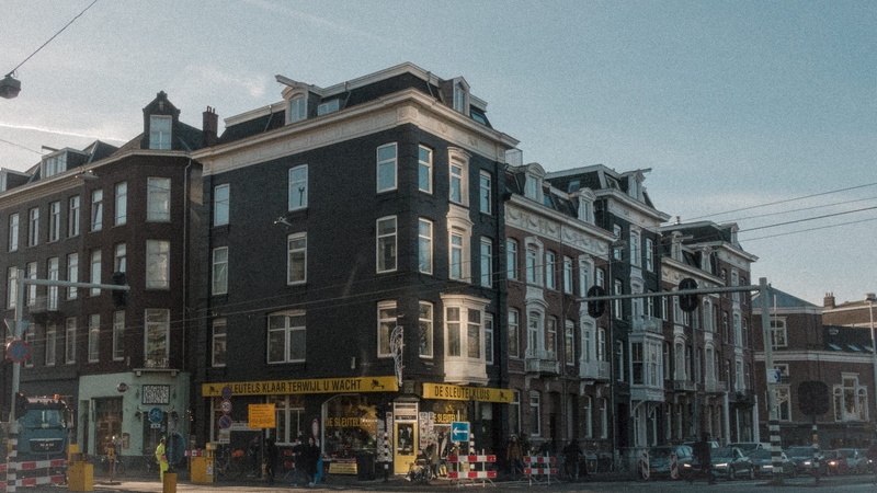 housing, sky, metropolis, building exterior, street, person, high rise, town, automobile, vehicle, road, amsterdam, built structure, apartment, window