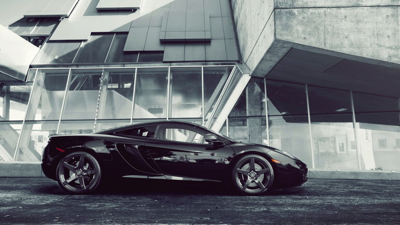 architecture, black, transportation, wealth, outdoors, city, luxury, coupe, built structure, mode of transportation, the building, modern, land vehicle