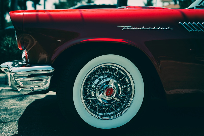 focus on foreground, land vehicle, outdoors, ford, technology, text, direction, car, retro styled, bumper, close-up, mode of transportation, ford thunderbird