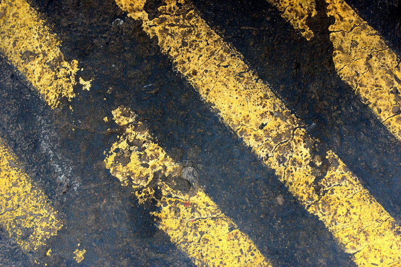 danger, transportation, asphalt, full frame, black and yellow, no people, symbol, road marking, industry, textured, high angle view, floor marking, sunlight
