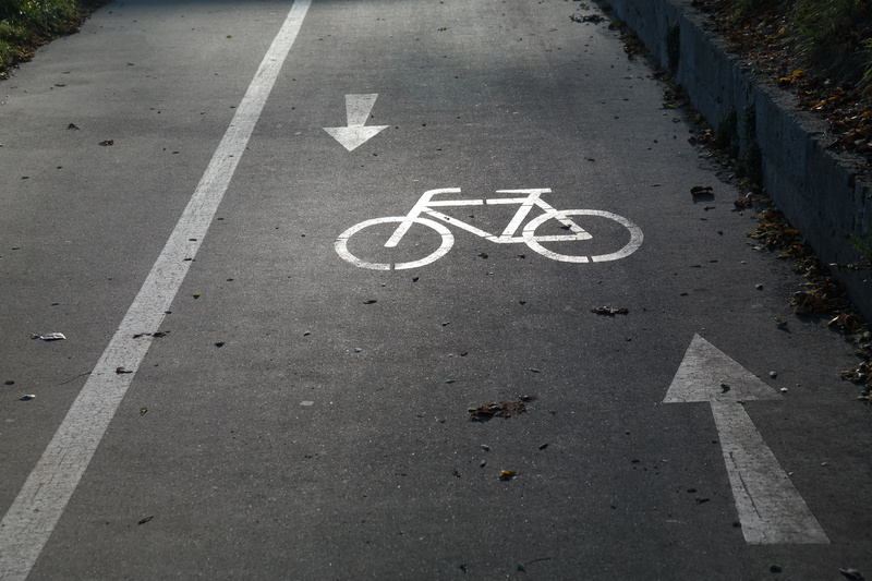 street, gauge, sign, bike, tar, high angle view, city, daytime, the way forward, symbol, transportation, bicycle path, day, asphalt, mark, road markings