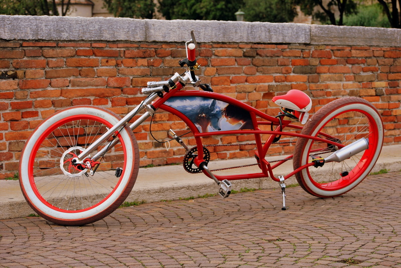 eccentric, outdoors, bricks, built structure, ray, land vehicle, bicycle, transportation, elongated, no people, wheel, wall, brick, pedals, paving stone