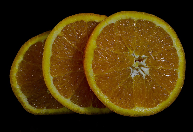 wheel, black background, orange, fruit, vitamins, no people, indoors, the rays, food, cross section, slice, fresh, studio shot, tropical fruit, the interior of the fruit