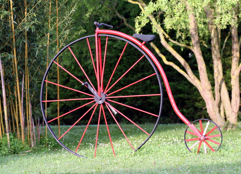 field, day, transportation, rays, former, green color, growth, cart, wheels, land, mode of transportation, draisienne, no people, outdoors, red, penny-farthing