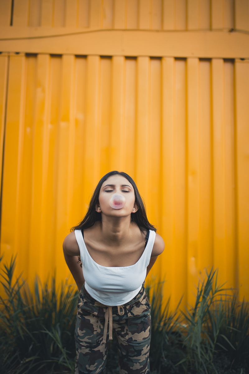 bubble gum, beauty, casual clothing, container, real people, posing, eyes closed, gum, contemplation, standing, lifestyles, near, 5K, yellow, hairstyle