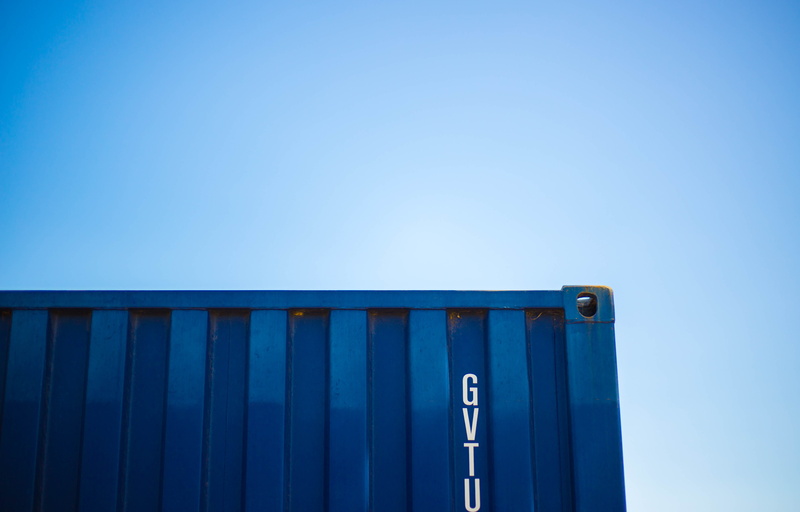 freight transportation, building, green, nature, low angle view, sunlight, container, corrugated, intermodal, blue, day, clear sky, no people, warehouse