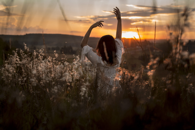 yoga, human arm, long grass, leisure activity, outdoors, real people, hands, rear view, female, field, petaled, middle, sunrise, women, adult, lifestyles
