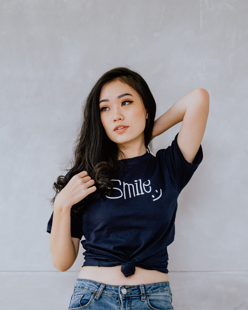 tied, t, young women, black hair, teenager, text, white, wall - building feature, standing, portrait, jeans, leisure activity, smile, real people, hairstyle