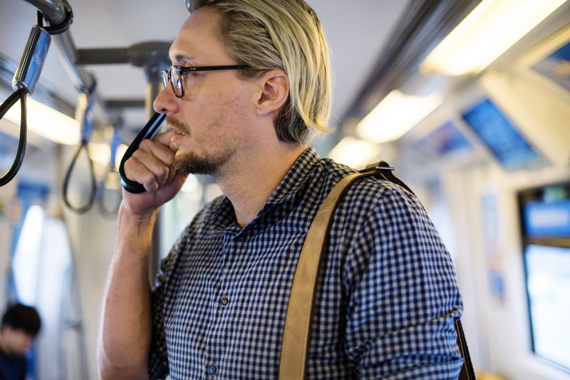 european, 4K, mid adult men, sharing, focus on foreground, phone, beard, glasses, connection, caucasian, indoors, smartphone, media, subway, community