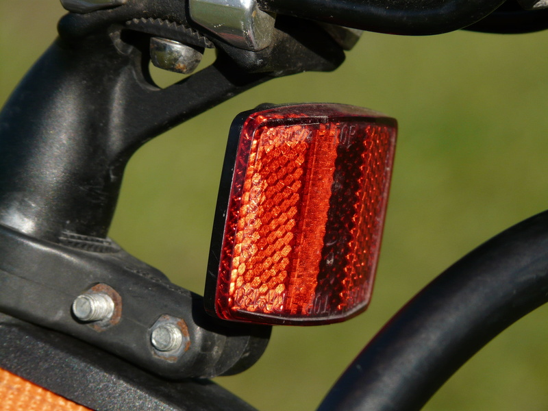 bike, back light, metal, orange color, close-up, 2K, red, machinery, lighting equipment, bicycle, focus on foreground, no people, technology, tire, reflector