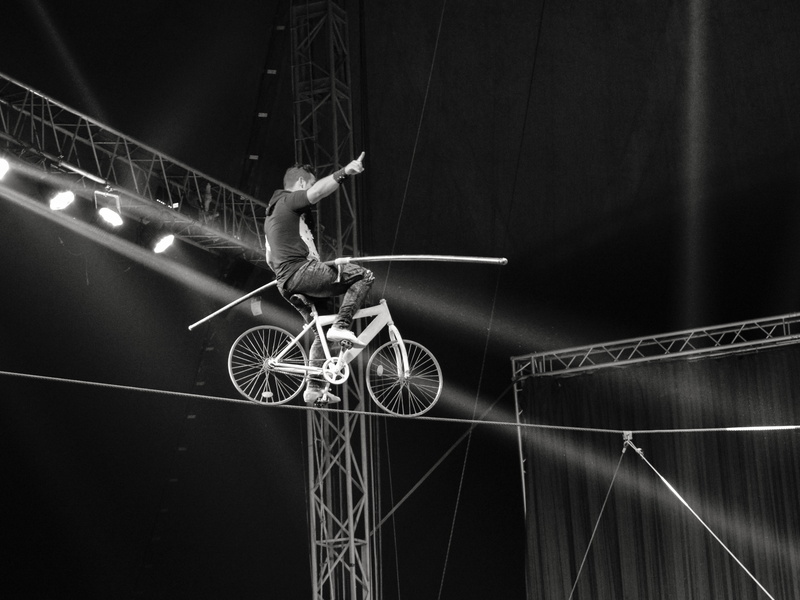 motion, one person, illuminated, balance, acrobat, lifestyles, circus, risk, cycling, dangerous, exercising, athlete, lighting, skill, strength, cable