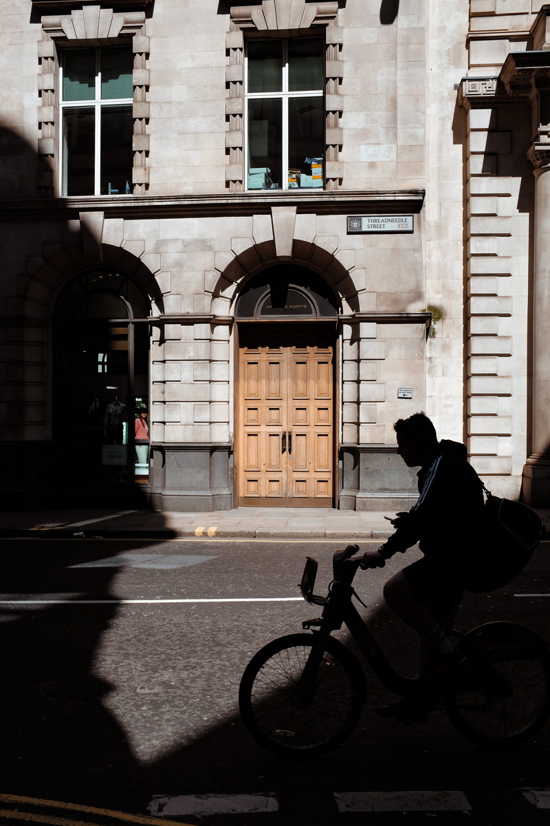 one person, sunlight, dark, men, transportation, day, city, phone, texting, shadow, street, street photography, architecture, arch, built structure, outdoors