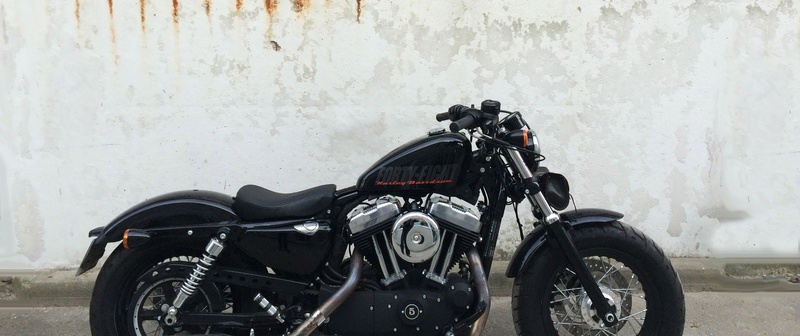wall, black color, side view, white, day, built structure, beside, retro styled, black, motorcycle, wall - building feature, parking, land vehicle, transportation