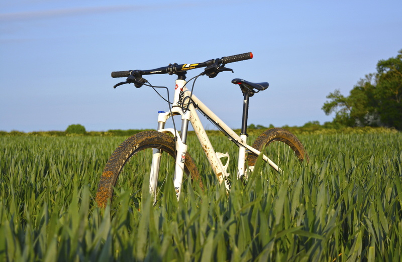 green, bicycle, hobby, bike, nature, day, no people, field, plant, transportation, home video camera, grass, environment, outdoors, rural scene, landscape