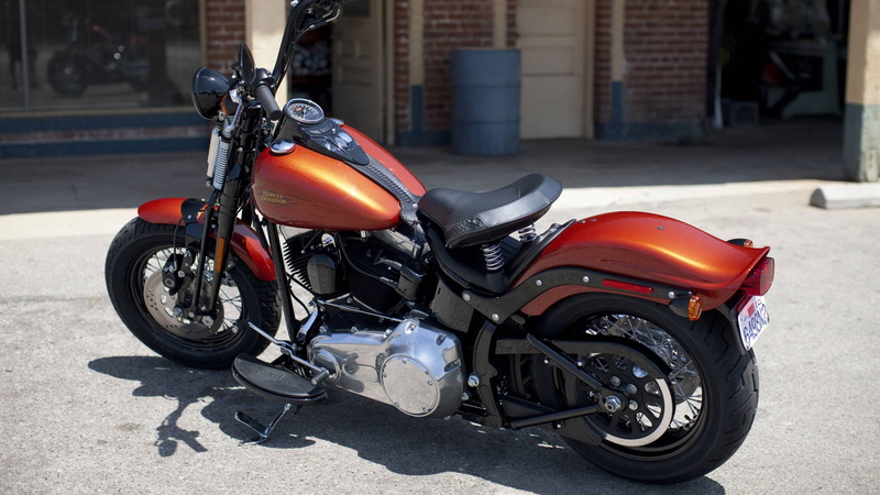 leather, transportation, road, sports helmet, vehicle, headwear, motorcycle, mode of transportation, crash helmet, orange, sunlight, black, helmet, architecture