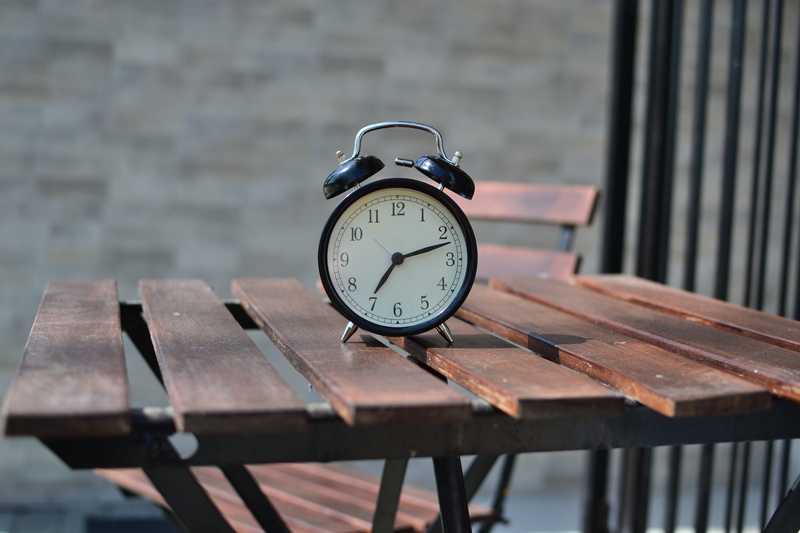 brown, chair, alarm clock, wood - material, top, brick wall, communication, day, focus, seat, no people, black, time, selective, focus on foreground, photography