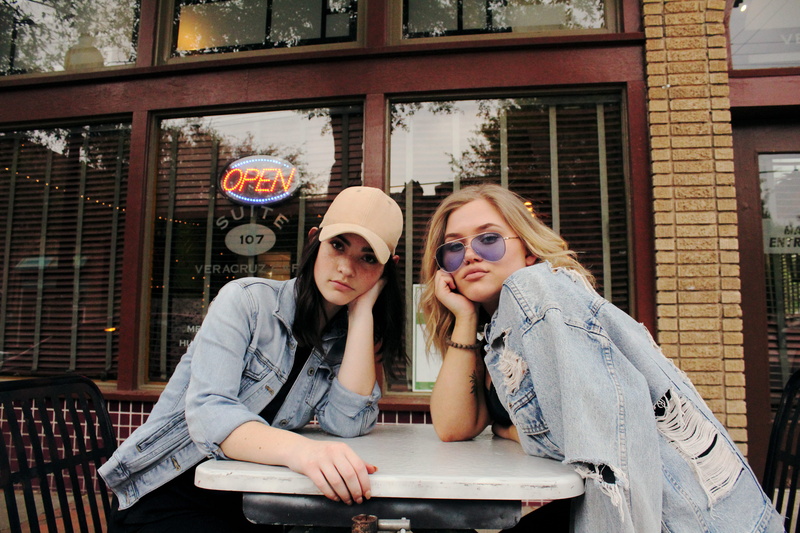 day, gray, architecture, building exterior, adults only, friendship, 5K, caucasian Ethnicity, sunglasses, city, built structure, sitting, sits, looking at camera