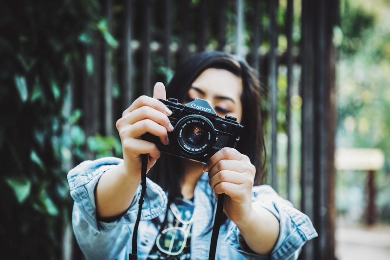 camera - photographic equipment, occupation, camera, technology, outdoors, lifestyles, focus on foreground, vintage camera, chambray, front view, wearing