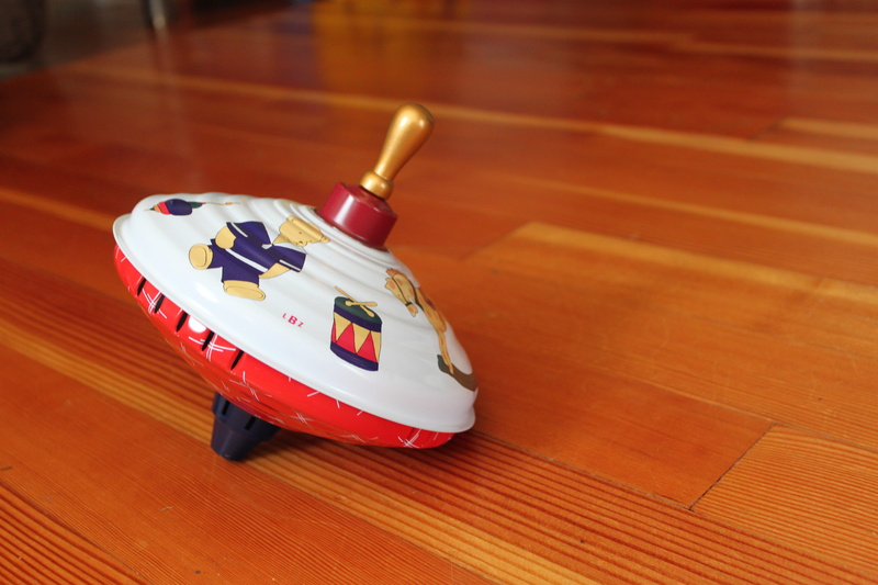 turn, playroom, play, toy, wood floor, car, close-up, wooden, indoors, focus on foreground, spin toy, traditional, 4K, parenthood, single object, classic