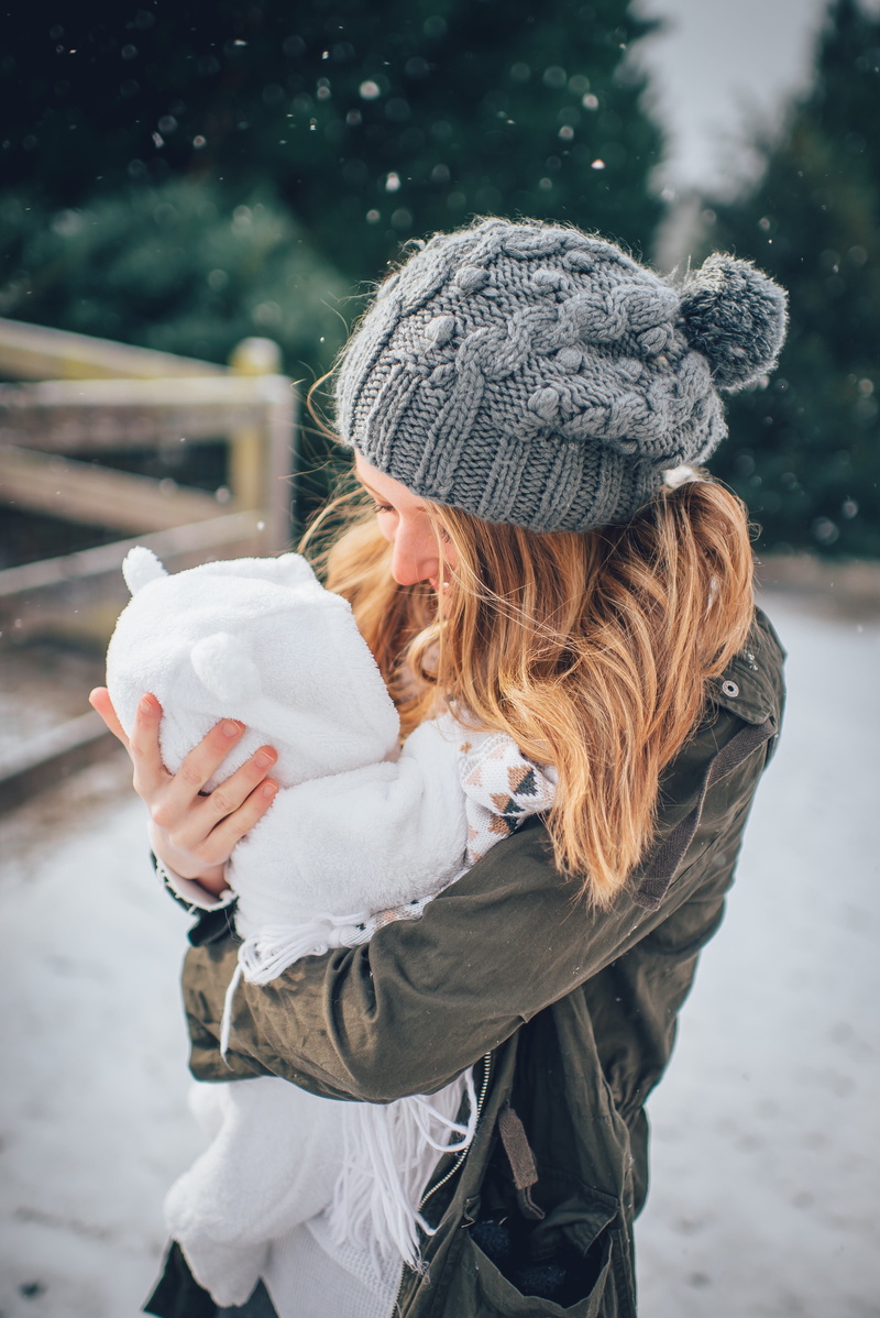 hair, scarf, snow, caucasian, love, woman, mom, parent, one person, generation, focus on foreground, infant, white, outdoors, baby, happiness, winter, holding