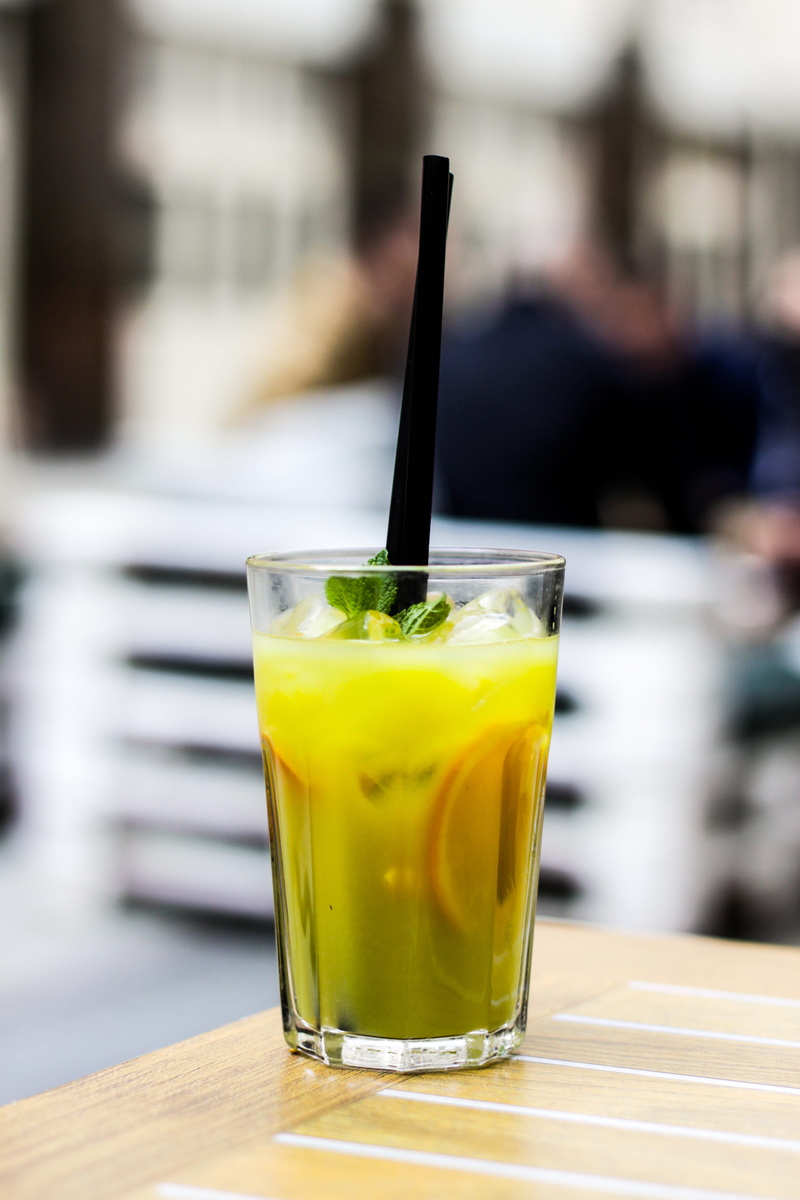 refreshment, focus on foreground, incidental people, drinking straw, table, mint leaf - culinary, bar, freshness, yellow, household equipment, food and drink