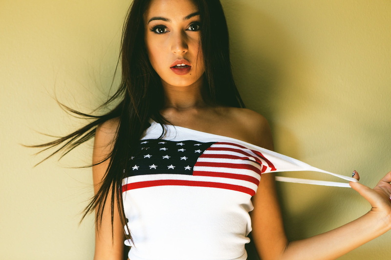 striped, indoors, young adult, real people, studio shot, hair, T-shirt, long hair, beautiful woman, looking at camera, portrait, open mouth, wall - building feature