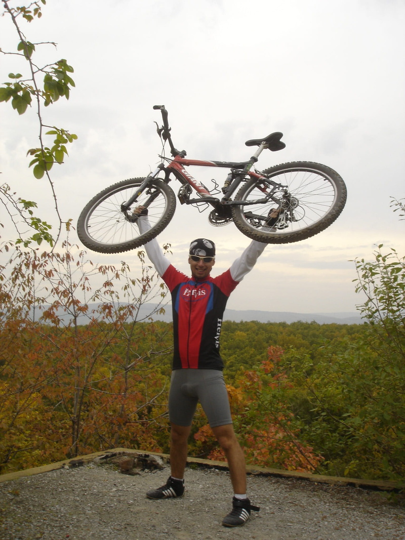 day, front view, mode of transportation, cycling, action, bicycle, human arm, leisure activity, adult, caucasian Ethnicity, adventure, outdoors, arms raised