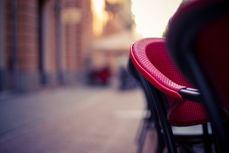 red, day, basket, 720P, bicycle, photography, close-up, focus on foreground, outdoors, absence, cafe, seat, blurred, chair, no people, selective focus