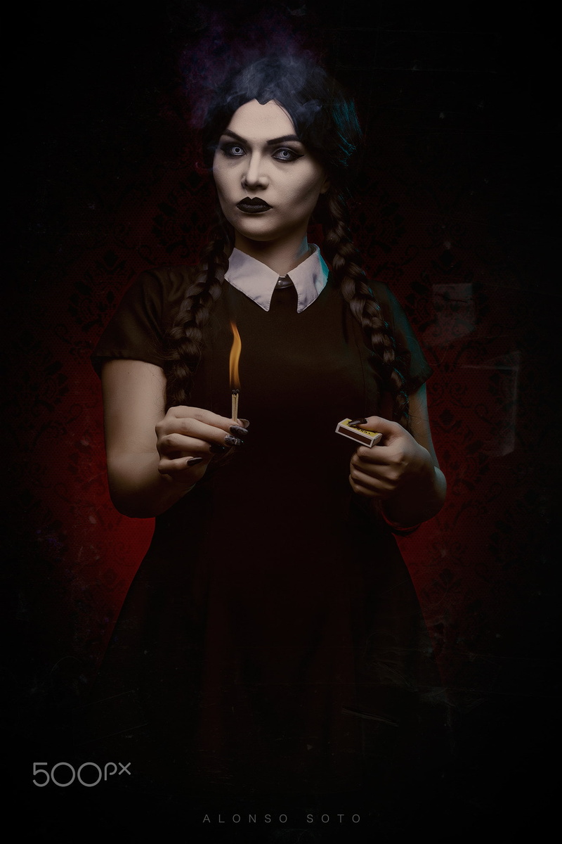 bizarre, gothic style, young adult, looking at camera, women, holding, sign, black background, spooky, matches, Alonso Soto, mystery, fire, knife - weapon