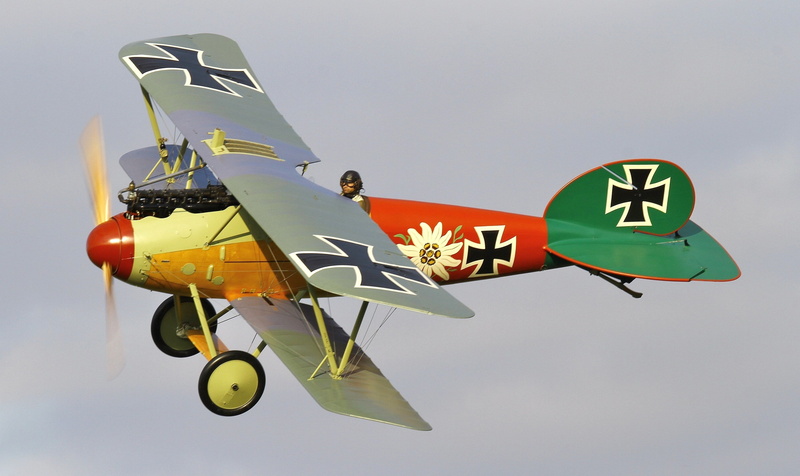 during, motion, replica, 2K, mode of transportation, sign, airplane, red, low angle view, sky, war, mid-air, outdoors, flying, communication, world, First