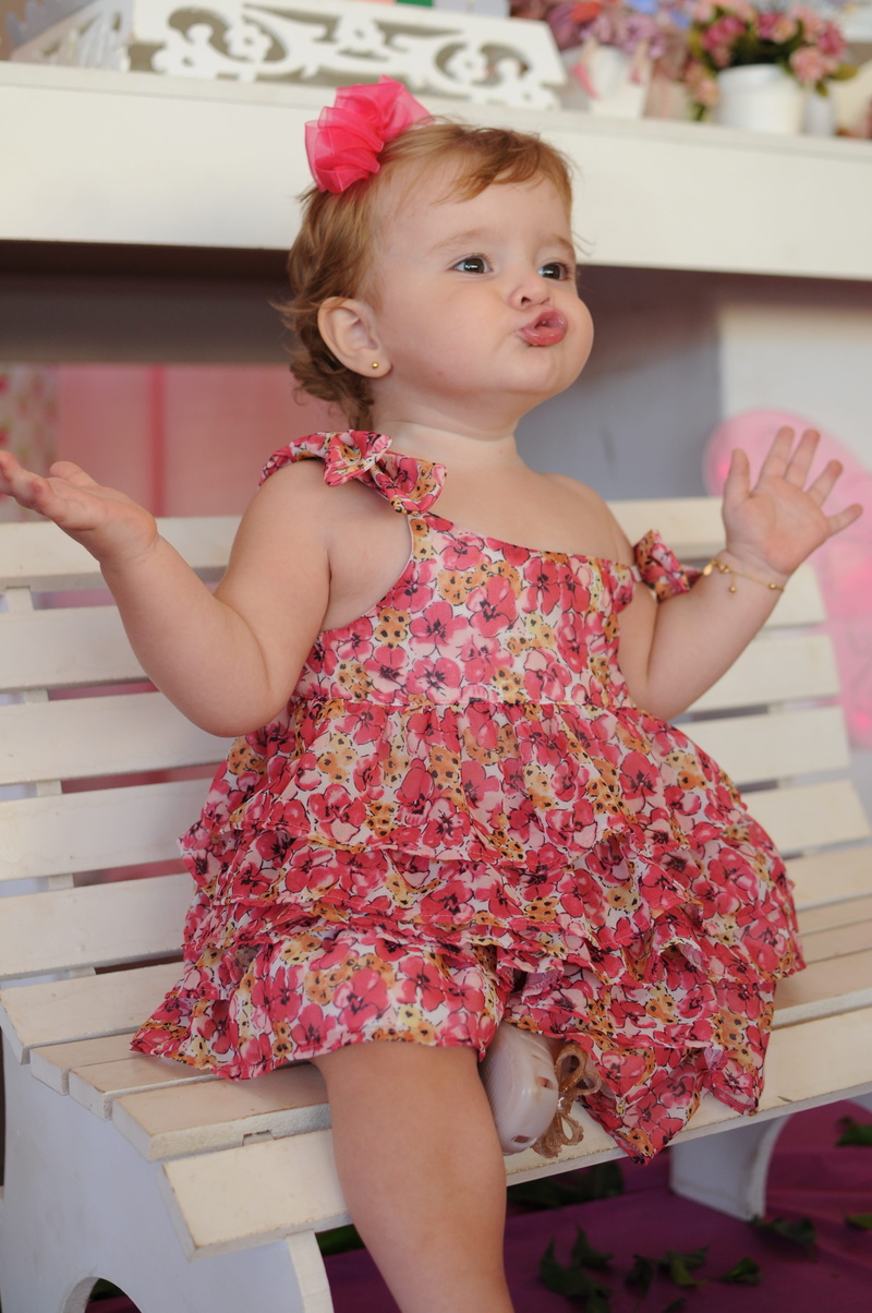 real people, girls, childhood, leisure activity, front view, child, holding, women, innocence, home interior, sitting, floral pattern, fashion, pout, cute