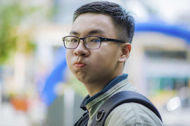 wear, looking away, black, headshot, man, gray, jacket, bokeh, outdoors, university, contemplation, boy, blur, daylight, eyewear, one person, happiness