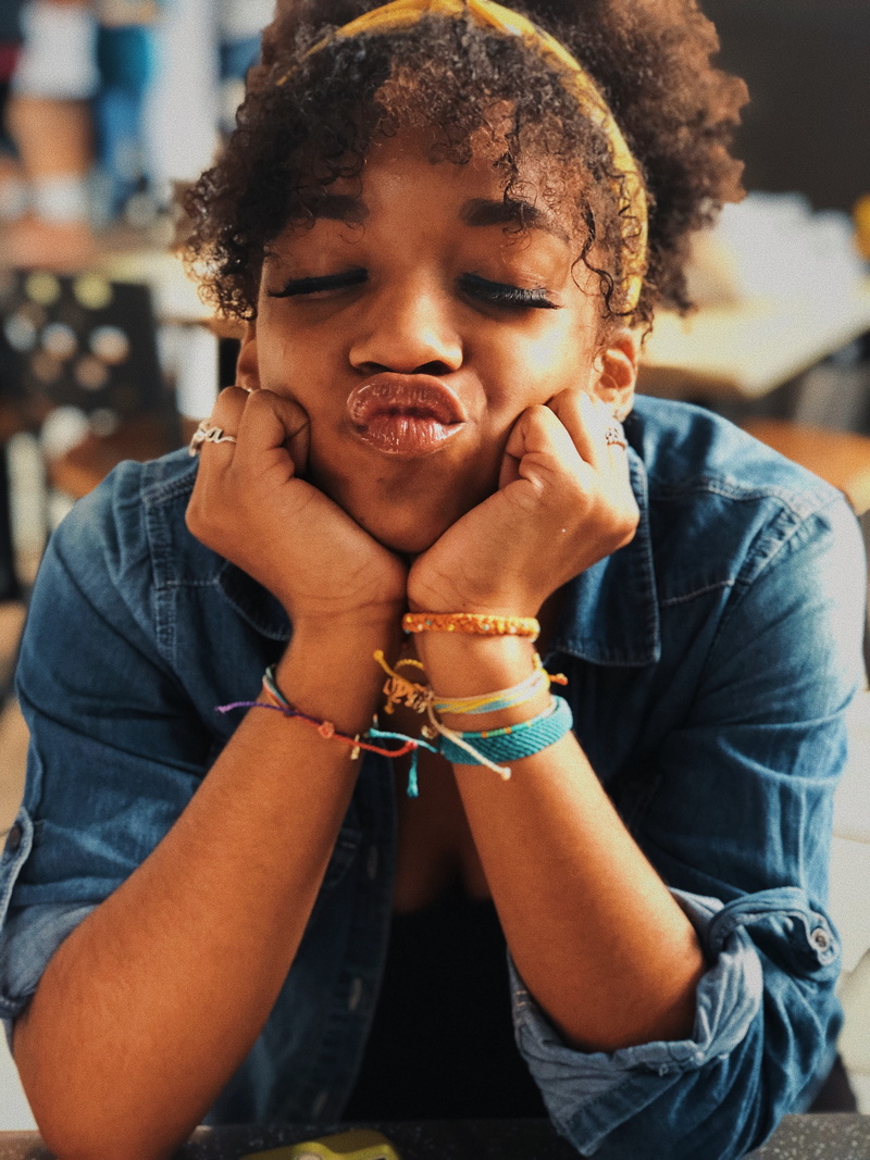 hairstyle, sitting, pouting, young adult, lips, contemplation, young women, 4K, leisure activity, focus on foreground, real people, lifestyles, hair, front view
