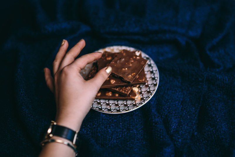 lifestyles, food, bar, personal perspective, real people, jeans, nut, indoors, time, nail, finger, wristwatch, human Hand, chocolate bar, 5K, close, dark