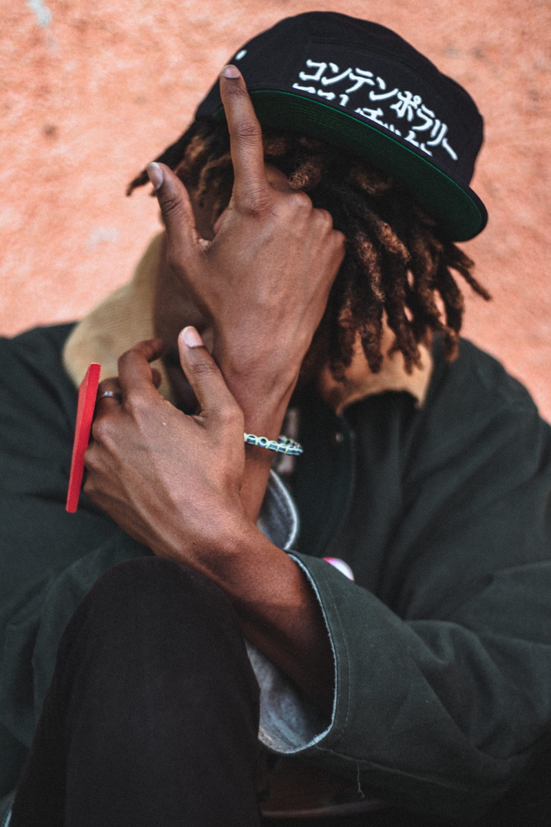 occupation, lifestyles, sitting, indoors, black, technology, hiding, leisure activity, person, hair, cover, rear view, hairstyle, wear, communication, casual clothing