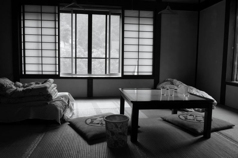black and white, bedroom, home interior, empty, no people, flooring, table, electric lamp, furniture, bed, glass - material, coffee table, comfortable