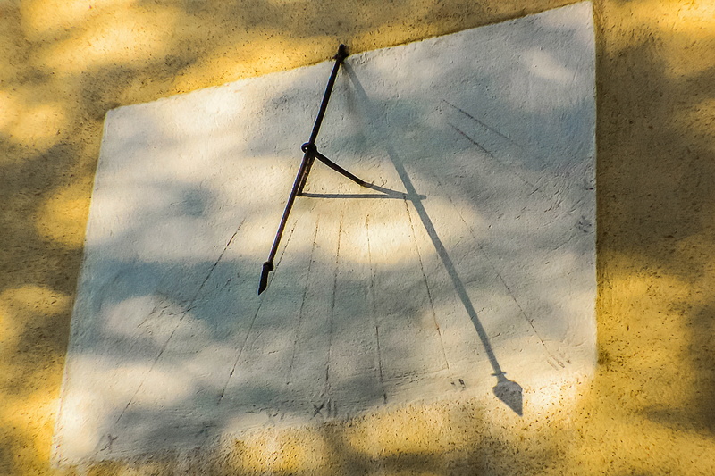 low angle view, no people, building, weathered, built structure, nature, sky, shadow, yellow, concrete, day, architecture, sundial, outdoors, wall - building feature