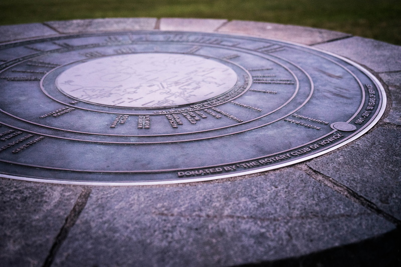 geometric shape, black, drain, howick, leather, 5K, masonry, outdoors, coin, no people, wristwatch, selective focus, sundial, street, high angle view