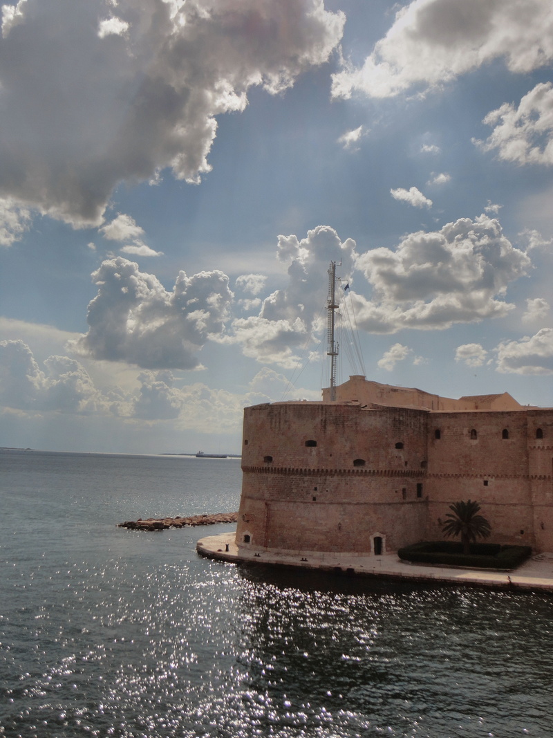 transportation, tower, sea, outdoors, building exterior, puglia, sky, beauty in nature, castle, nature, horizon over water, built structure, horizon, taranto