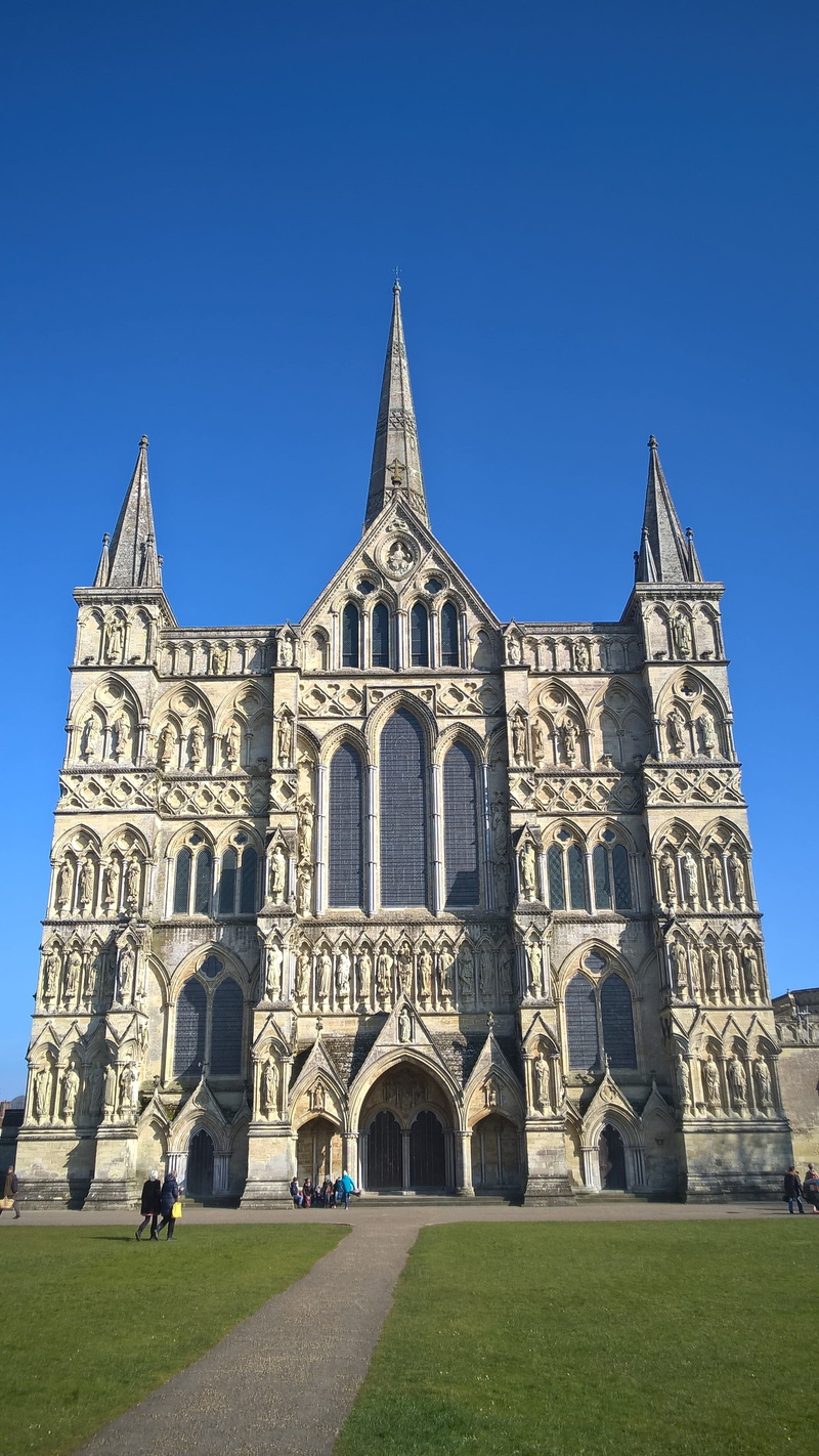 salisbury, belief, low angle view, facade, religion, place of worship, gothic, cathedral, spirituality, blue, built structure, clear sky, history, incidental people