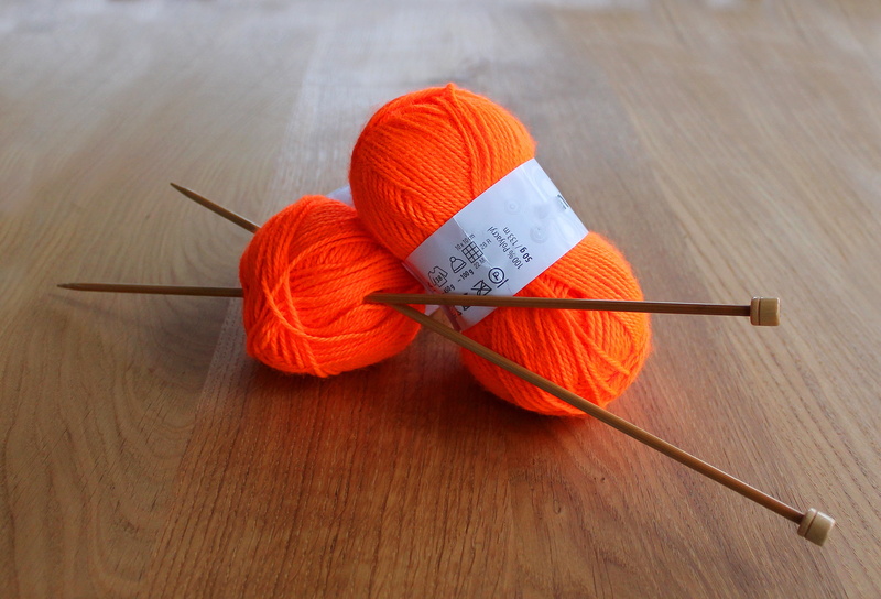 close-up, text, art and craft, thread, handwork, creativity, group of objects, high angle view, orange, indoors, craft, knitting needles, yarn, knitting needle