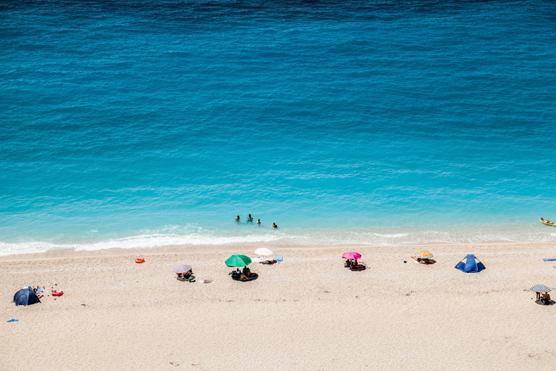 life, summer, land, seashore, outdoors, lifestyles, blue, day, incidental people, colour, scenics - nature, near, holiday, the beach, group of people, greek island