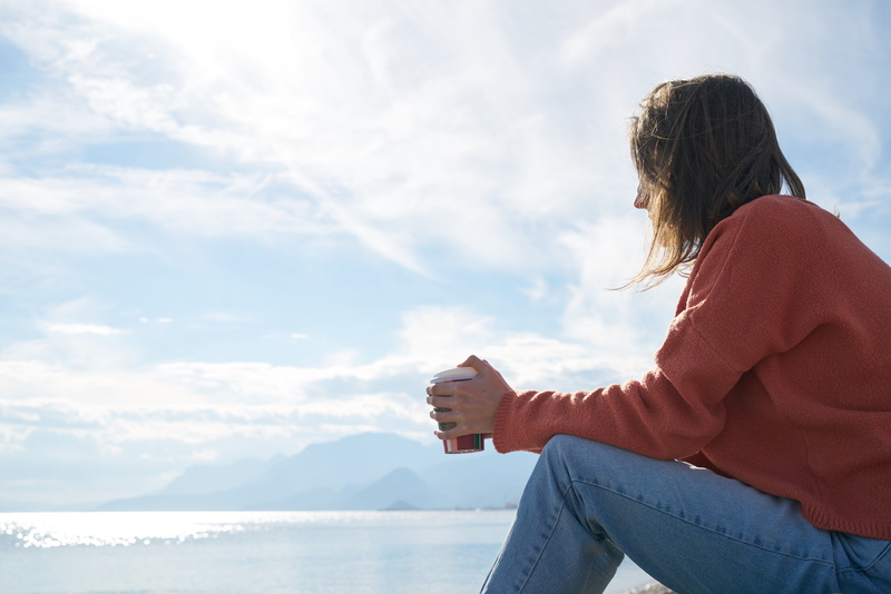 jeans, daylight, hair, loneliness, side view, beach, ocean, beauty in nature, fashion, recreation, sea, landscape, summer, lifestyles, hairstyle, person